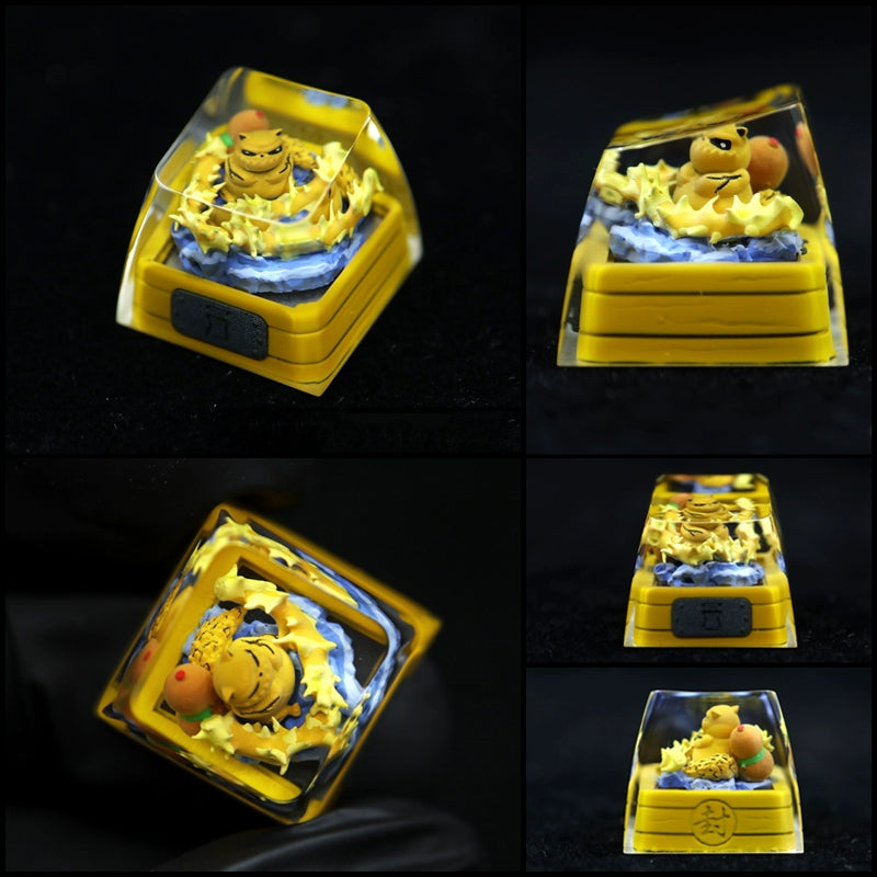 Collage featuring a novelty keycap from the Tailed Beasts Naruto Keycaps collection, depicting a yellow creature amid blue waves and yellow lightning. It&