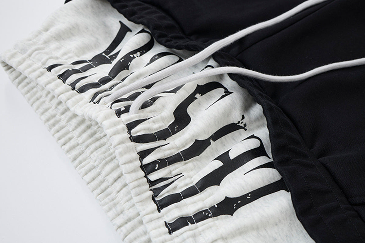Pantalon de survêtement ample à jambes larges avec bandes latérales, fausse double ceinture et imprimé graphique