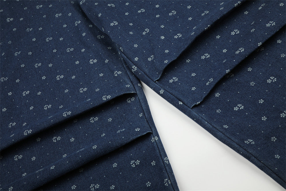 Close-up of layered leg panels on dark blue floral print baggy jeans