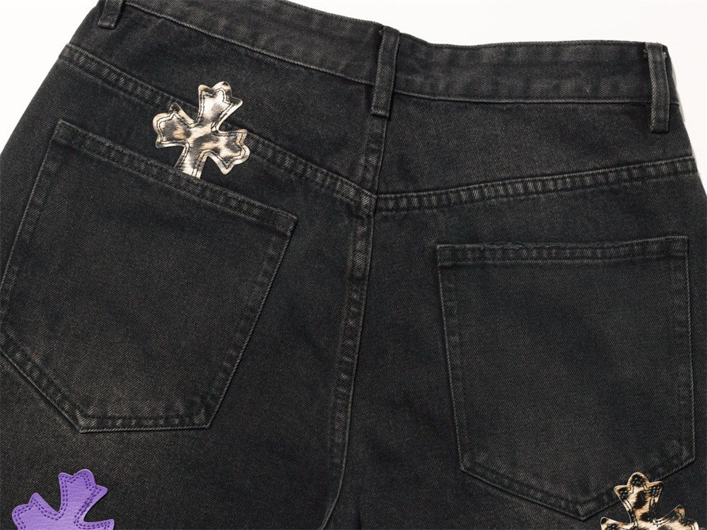 Back waistband of black jeans with leopard cross patch and rear pockets