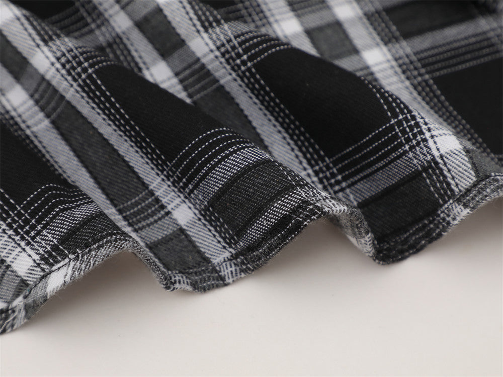 Close-up of black plaid flannel hem with soft curved edge