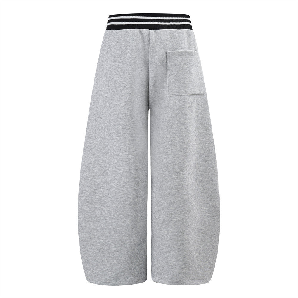 Pantalon de survêtement large à lettrage graffiti avec ceinture croisée contrastante à rayures