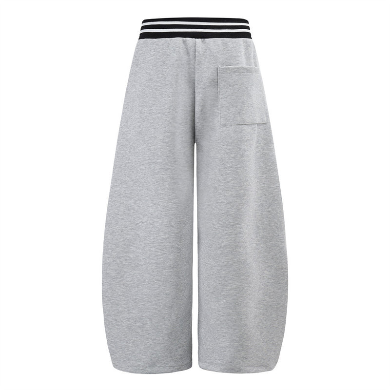 Pantalon de survêtement large à lettrage graffiti avec ceinture croisée contrastante à rayures