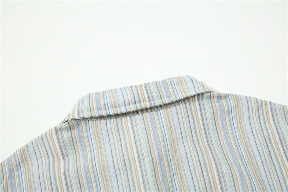 Close-up of shirt collar back on striped fabric