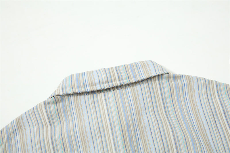 Close-up of shirt collar back on striped fabric