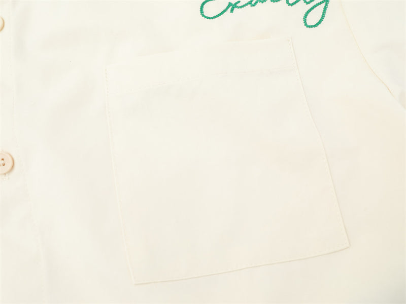 Cream chest pocket close-up on button-down shirt with subtle stitching detail