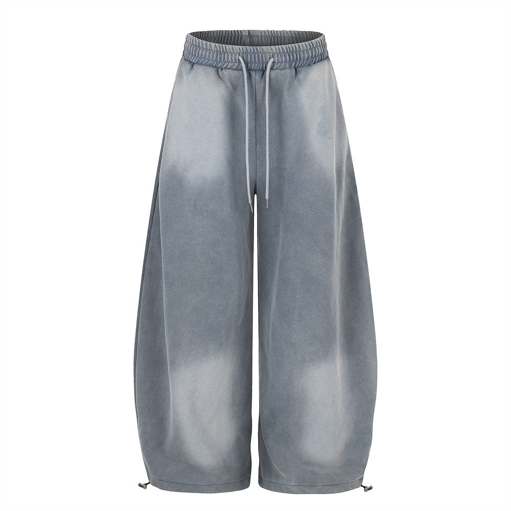 Oversized wide-leg acid wash sweatpants in washed gray-blue with elastic drawcord waist and adjustable hem, front and back vi