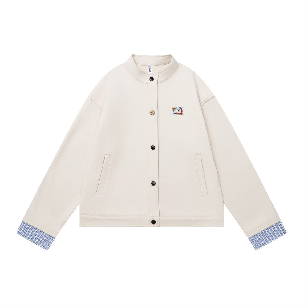Men's off-white stand collar button-up short jacket with blue plaid contrast cuffs and embroidered chest patch, front view