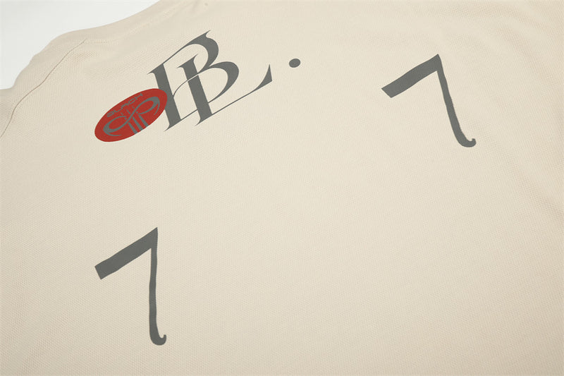 Beige tee back detail with logo at the neckline and large number print
