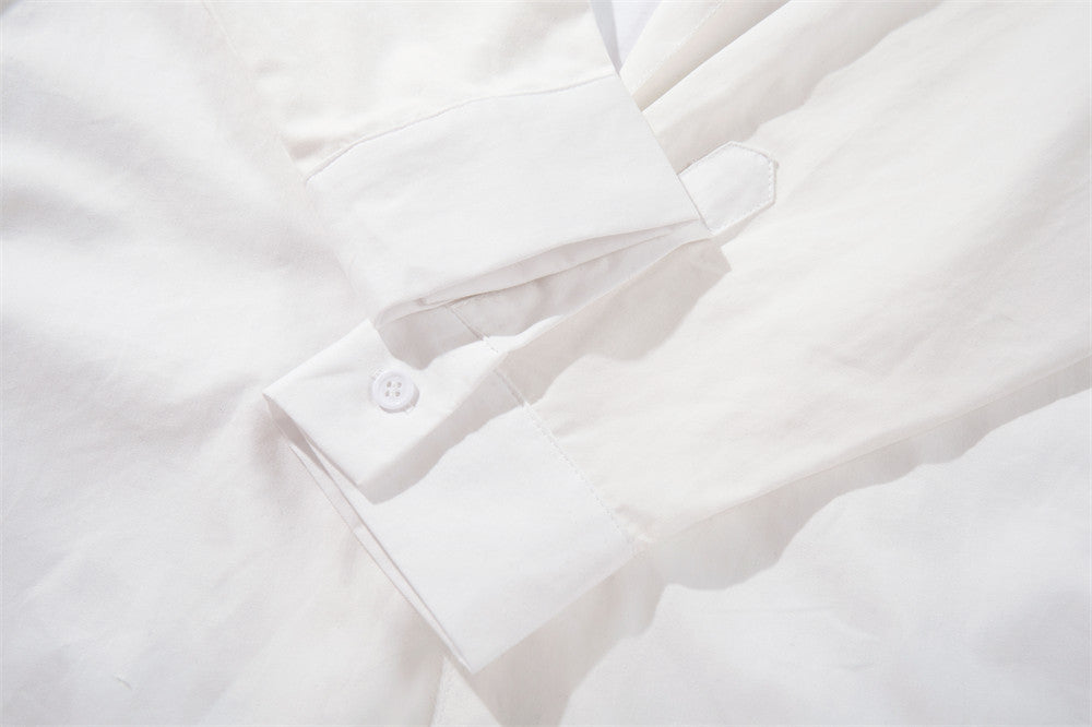 White sleeve cuff close-up with button closure