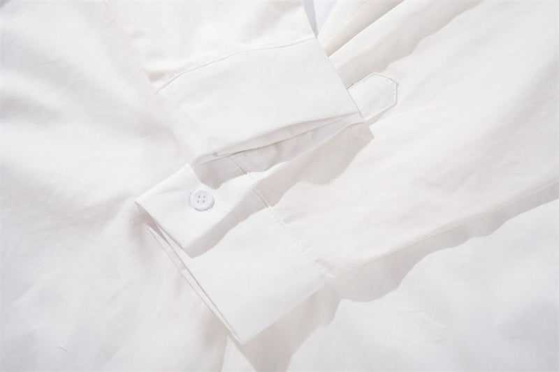 White sleeve cuff close-up with button closure