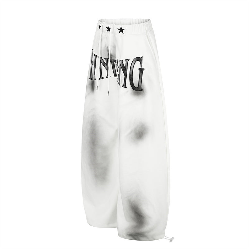 Pantalones de chándal holgados de pernera ancha con lavado efecto spray y gráfico de letras