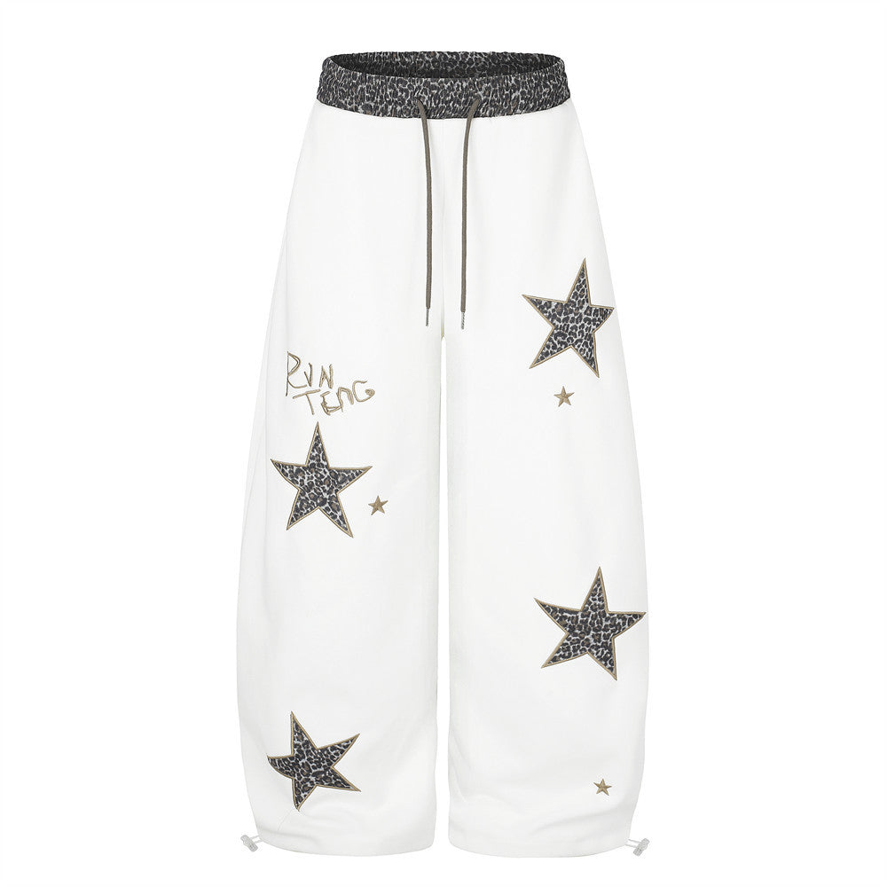 Wide leg sweatpants with oversized leopard-print star appliqués and contrast leopard waistband in white and navy