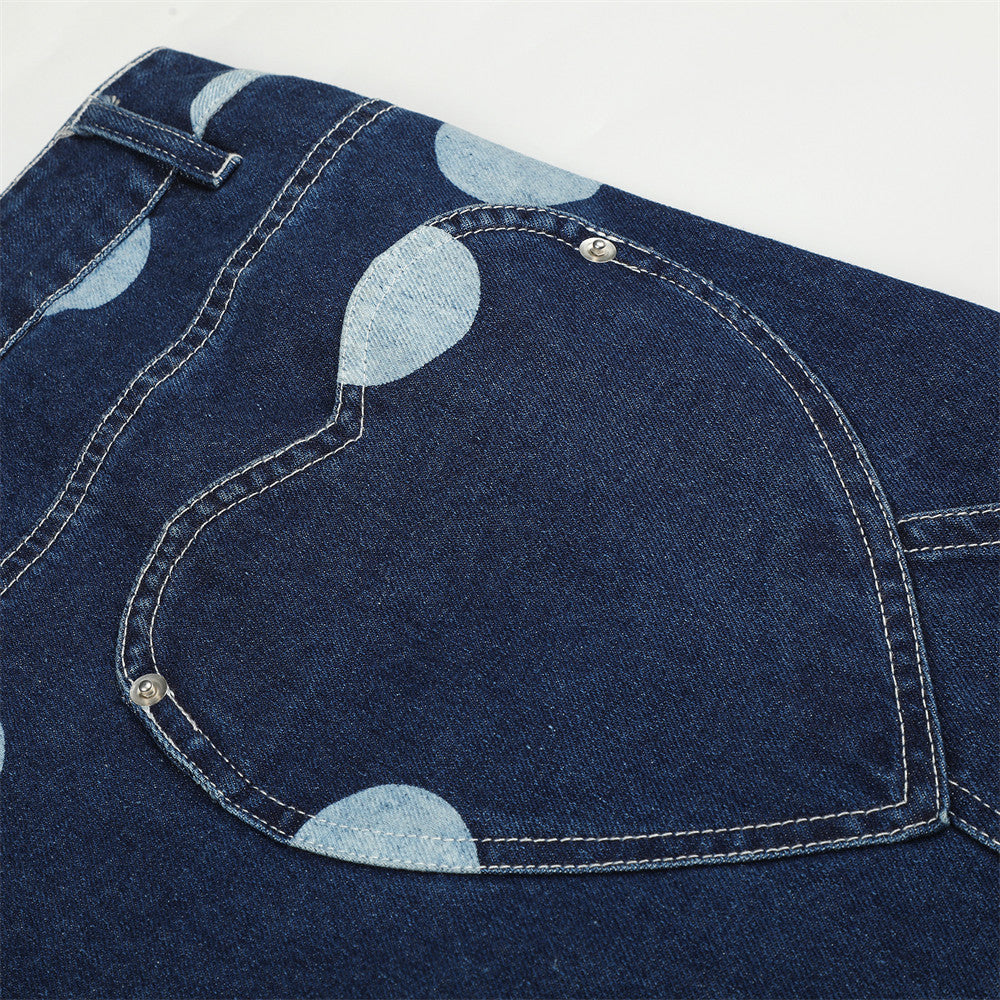 Close-up of heart-shaped back pocket on dark wash polka dot jeans