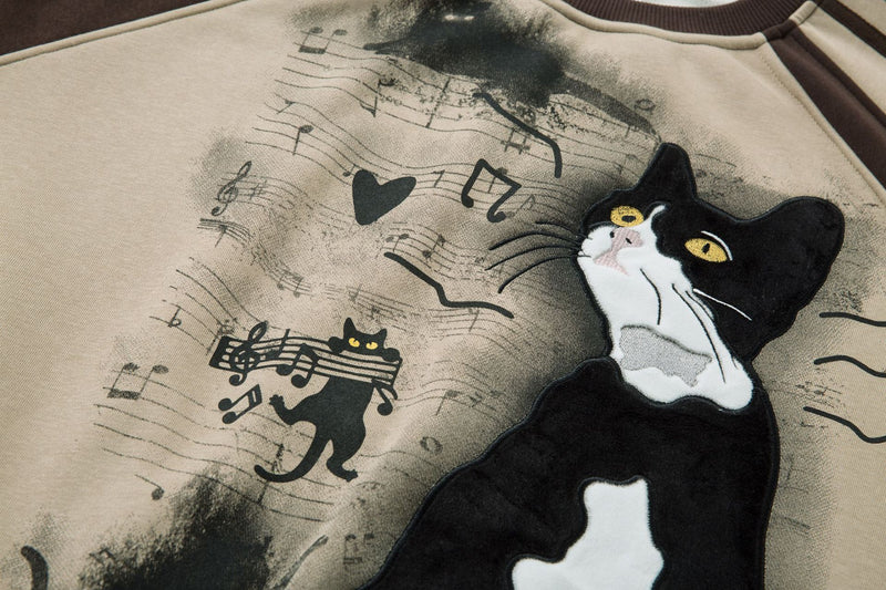 Sweat-shirt motif chat en smoking avec imprimé note de musique et manches raglan color block