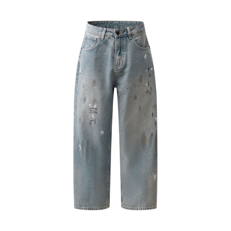 Full front view of vintage washed blue jeans with paint splatter details
