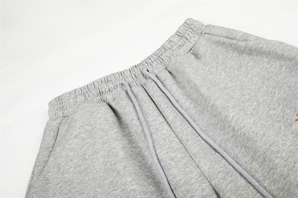 Close-up of gray sweatpants waistband with elastic gather and drawstring