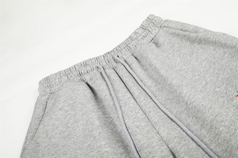 Close-up of gray sweatpants waistband with elastic gather and drawstring