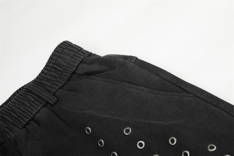 Pantalon de survêtement ample à œillets métalliques, finition délavée à l’acide & ourlet brut