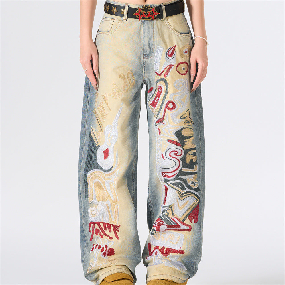 Punk graffiti embroidered wide-leg distressed jeans in vintage washed light blue denim, front and back view