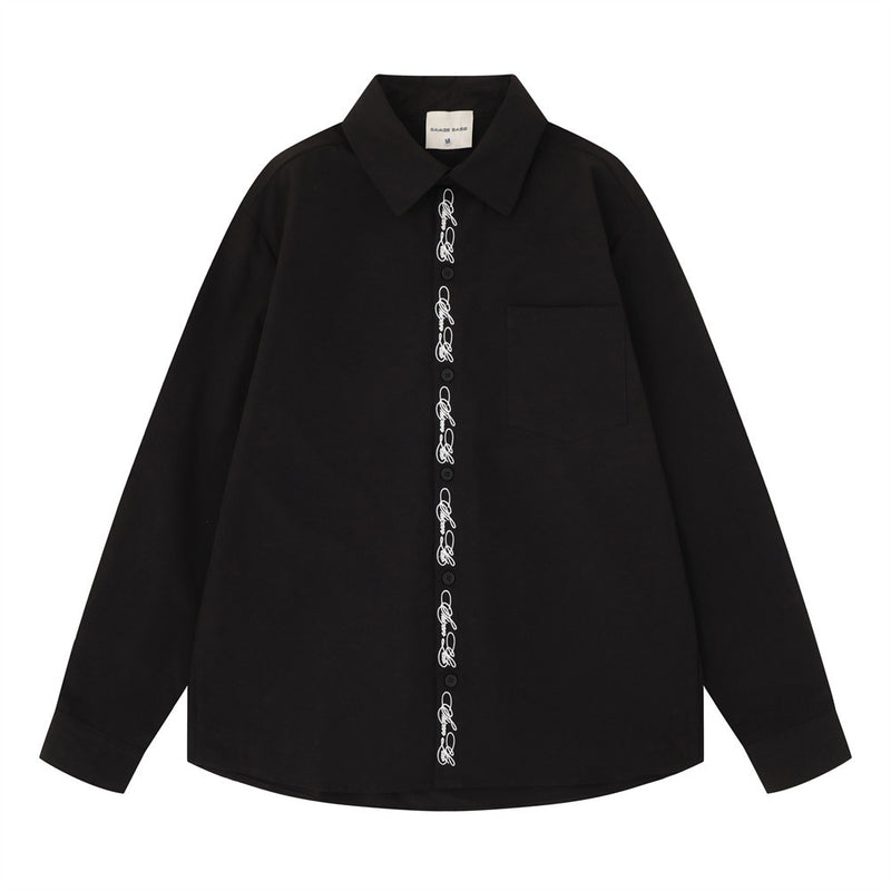 Oversized long-sleeve button-down shirt with script embroidery placket shown in black and off-white colorways