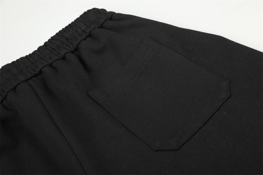 Pantalon de survêtement homme à jambes larges, motif graphique – Écusson licorne et slogan imprimé noir