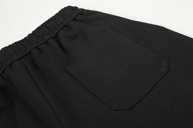 Pantalon de survêtement homme à jambes larges, motif graphique – Écusson licorne et slogan imprimé noir
