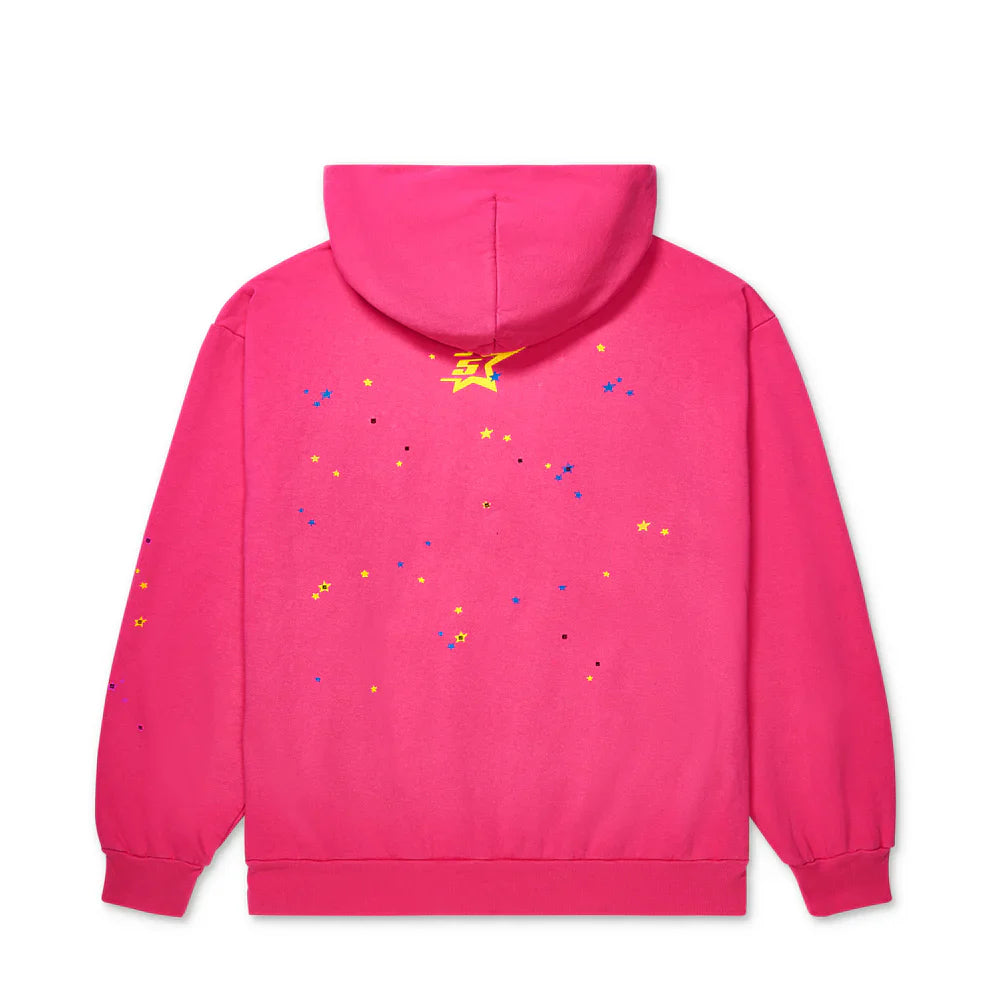 The Sp5der “Nevermind the Punk” Hoodie – Hot Pink 440GSM Heavyweight Pullover is shown from the back, with scattered yellow, blue, and black star-shaped designs and a large yellow graphic near the top center below the hood.