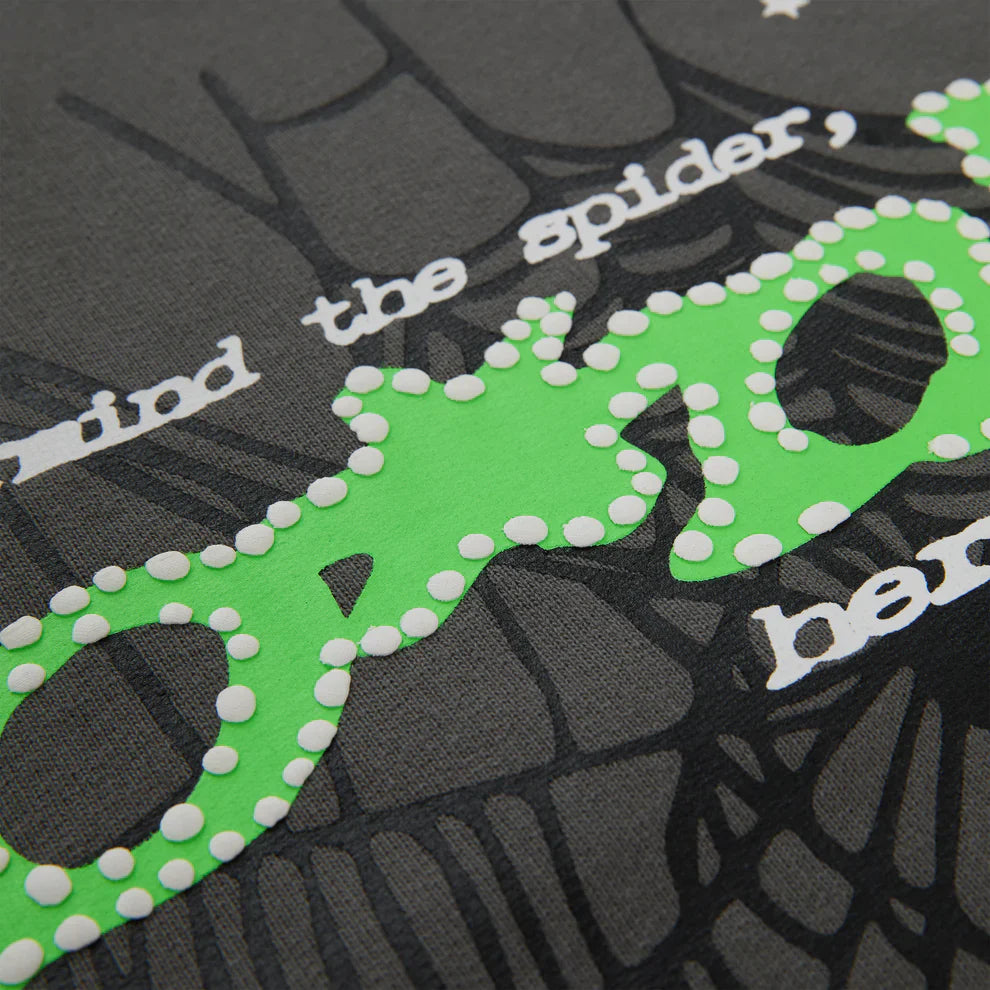 Close-up of the Sp5der “P!nk! Hares the Slime” Hoodie—an olive green 440GSM heavyweight spider-web pullover, featuring bold streetwear style with eye-catching graphics and premium cotton fleece.