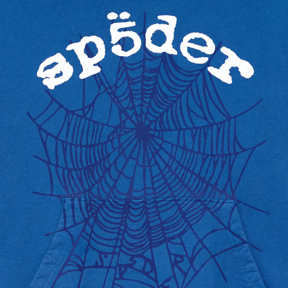 A blue background with a large, dark blue spider web and “sp5der” in white rounded text above, inspired by the Sp5der OG Web Hoodie 440GSM – a royal blue heavyweight cotton sweatshirt featuring the iconic spider-web graphic.