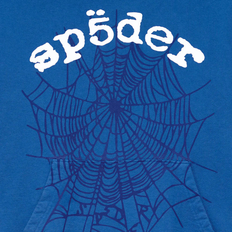 A blue background with a large, dark blue spider web and “sp5der” in white rounded text above, inspired by the Sp5der OG Web Hoodie 440GSM – a royal blue heavyweight cotton sweatshirt featuring the iconic spider-web graphic.