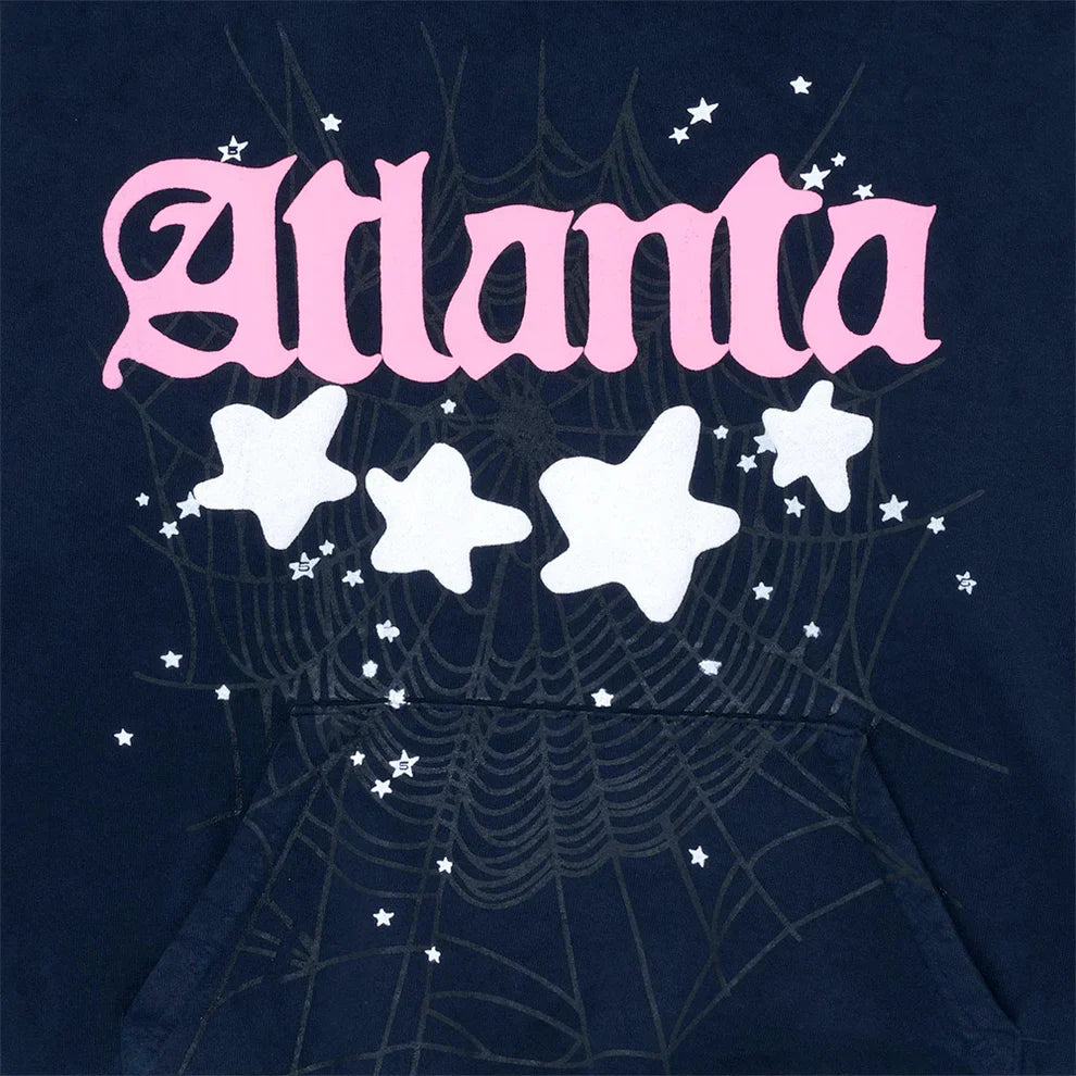 The Sp5der “Atlanta Nights” Web Hoodie is a navy blue, 440GSM heavyweight cotton pullover featuring "Atlanta" in bold pink letters, white stars, and a subtle black web design—perfect for fans of oversized streetwear.