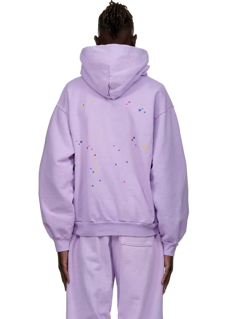 Person seen from the back wearing a Sp5der "Hares the Slime" Hoodie—Lavender Purple 440GSM Heavyweight Spider-Web Streetwear Pullover with matching pants, hood up, set against a plain white background. Features small colorful dot patterns.