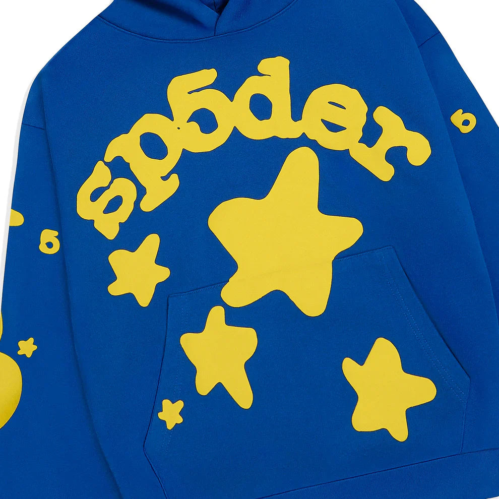 The Sp5der 440GSM Heavyweight Hoodie in royal blue features bold yellow star 3D puff prints on premium cotton fleece—a striking Y2K streetwear essential.