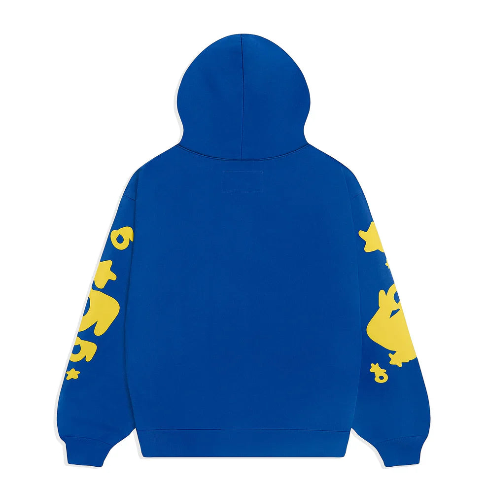 The Sp5der 440GSM Heavyweight Hoodie in royal blue showcases yellow star 3D puff prints on the sleeves, combining bold Y2K streetwear vibes with premium cotton fleece comfort. The back remains plain for a clean finish.