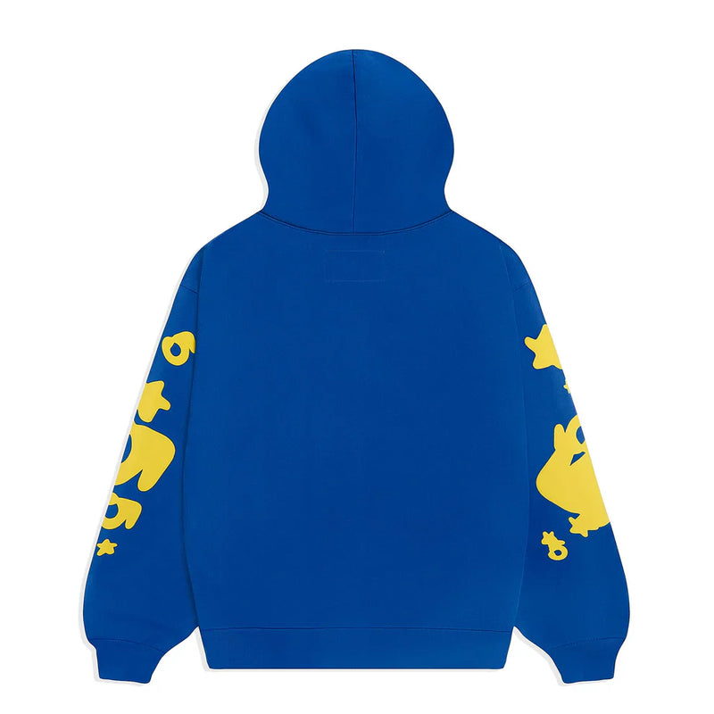 The Sp5der 440GSM Heavyweight Hoodie in royal blue showcases yellow star 3D puff prints on the sleeves, combining bold Y2K streetwear vibes with premium cotton fleece comfort. The back remains plain for a clean finish.