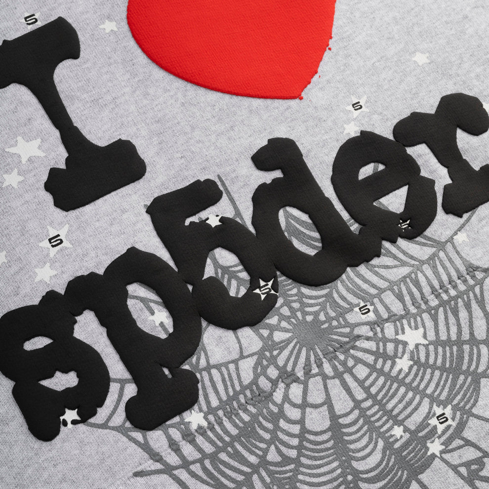 Close-up of the Sp5der “I Love Sp5der” Hoodie: a grey 440GSM heavyweight oversized pullover featuring “I ❤️ spider” with red heart, black lettering, white stars, and spiderwebs—perfect for Y2K streetwear fans.