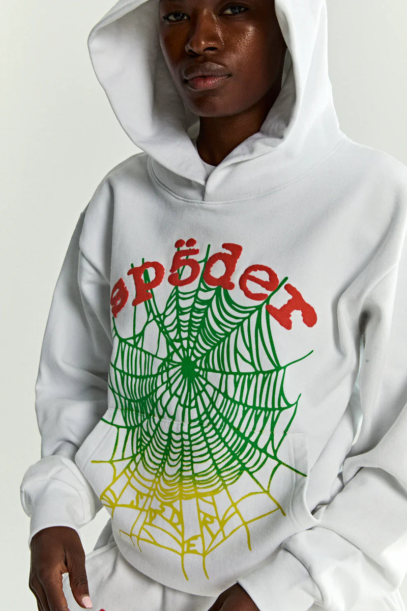Wearing the Sp5der “Toxic Web” Hoodie—White & Neon Lime, a 440GSM heavyweight oversized streetwear pullover—a person stands with the hood up against a plain background.