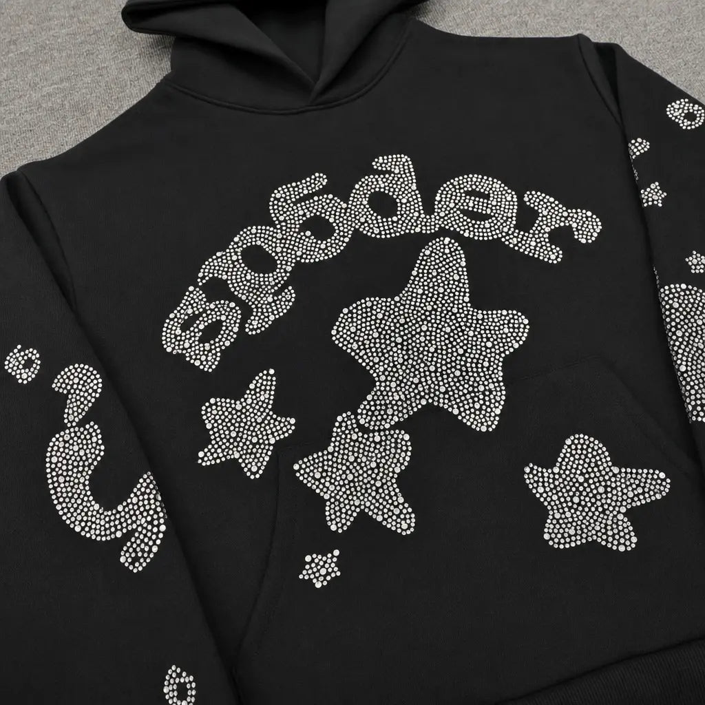 The Sp5der Black Rhinestone Star Logo Hoodie, made from 100% cotton, features sparkling rhinestone stars and "Sp5der" across the chest—a must-have black hoodie for your streetwear collection.