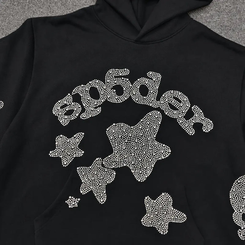 The Sp5der Black Rhinestone Star Logo Hoodie is made from 100% cotton and features "Sp5der" and star designs on the front in white rhinestones—ideal for streetwear style.