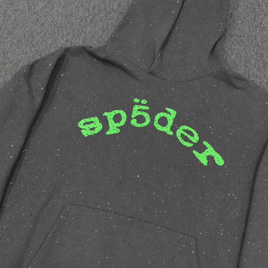 The Sp5der Dark Grey Rhinestone Hoodie Green Arch Logo features bold green arch text and a streetwear vibe—ideal for those seeking the iconic rhinestone hoodie style.