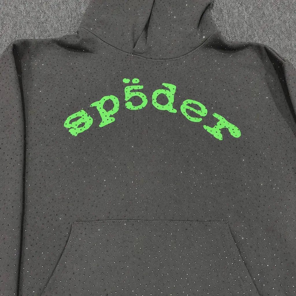 The Sp5der Dark Grey Rhinestone Hoodie Green Arch Logo features dark grey fabric, small sparkling rhinestones, and a bold green arch "sp5der" logo on the chest—an ideal streetwear piece.