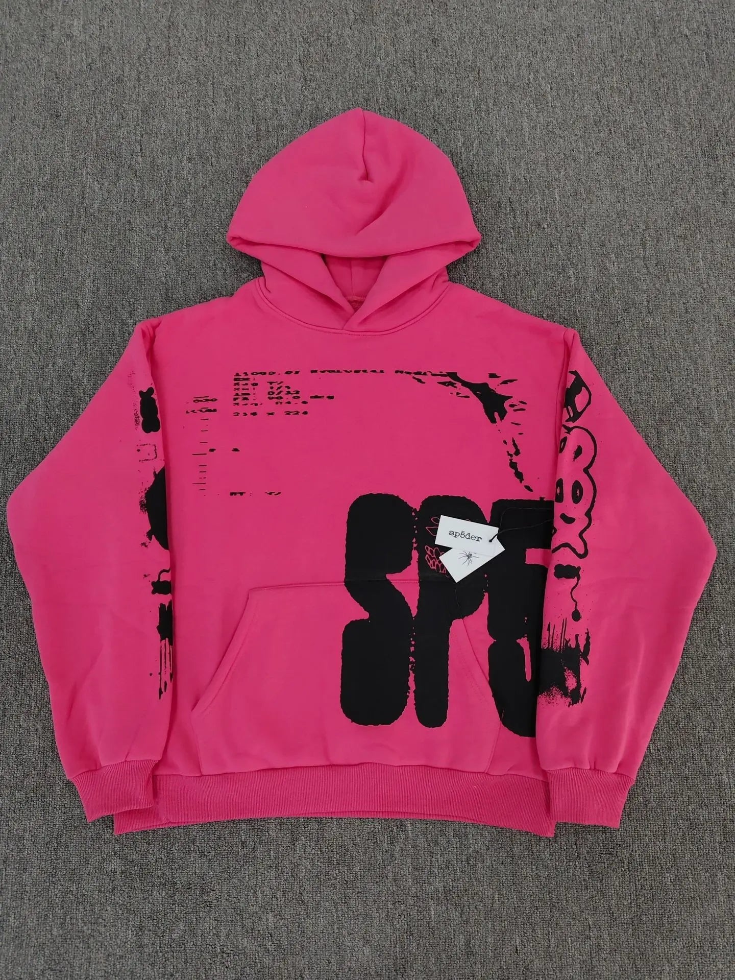 Sp5der hot pink hoodie with bold black graffiti text print on chest and sleeves laid flat