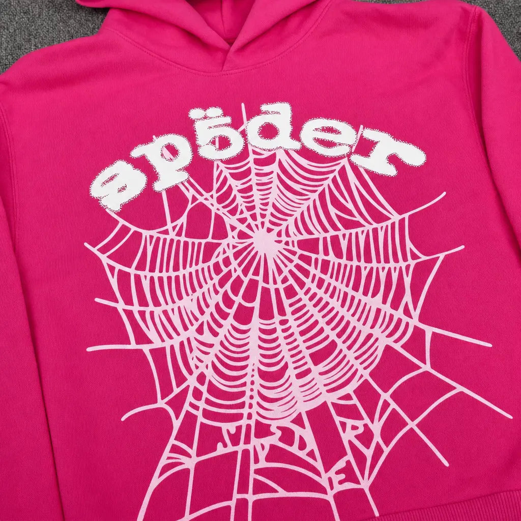 The Sp5der OG Web Hoodie Hot Pink features a bold white spiderweb front print and playful "spider" lettering—a standout, eye-catching piece for any streetwear collection.