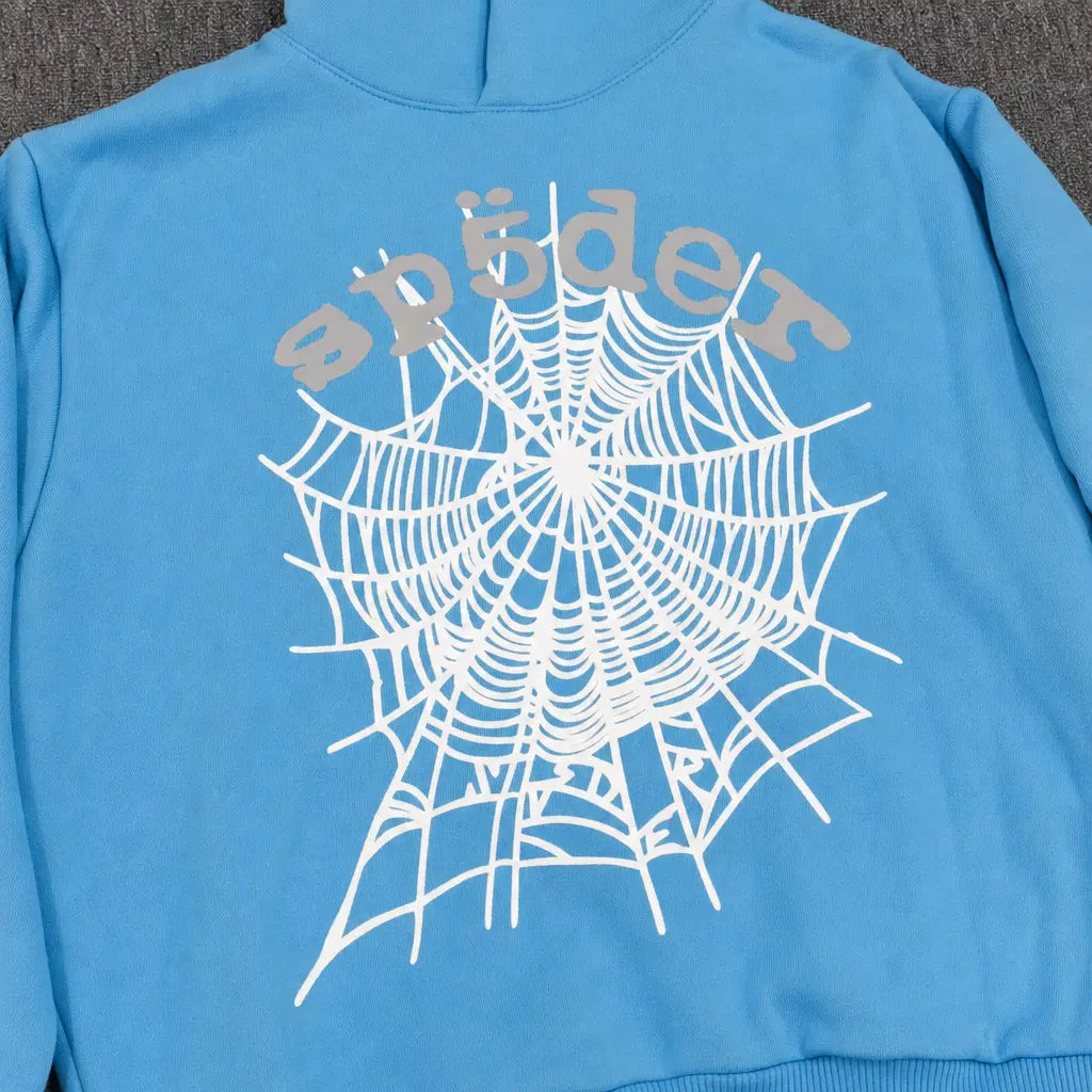 The Sp5der Sky Blue OG Web Hoodie features a striking white spiderweb back print and "sp5der" in stylized light gray text, making it a standout piece for any streetwear collection.