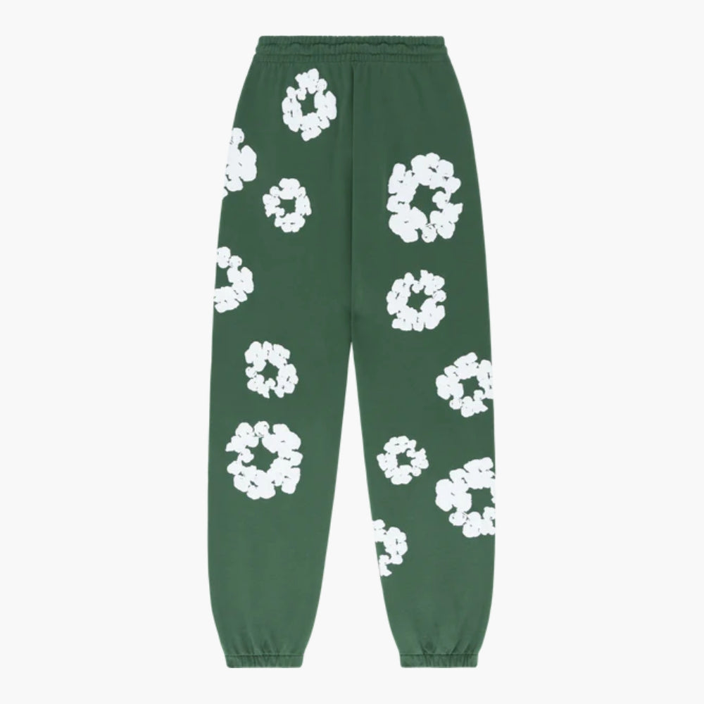 Forest Green “Cotton Wreath” Denim Tears sweatpants with an elastic waistband and cuffs, featuring a scattered large white floral print for a standout streetwear look.