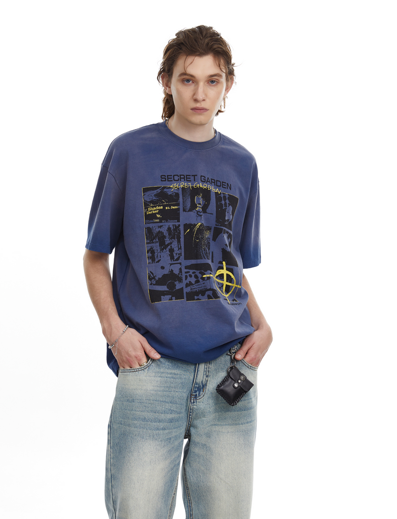 Oversized blue graphic T-shirt with Secret Garden panel print, worn with light wash jeans and a chain wallet
