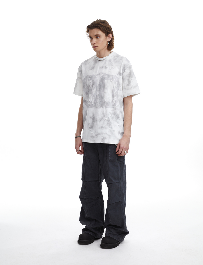 Oversized marble wash graphic tee with large number print, worn with dark cargo pants and black shoes on a model