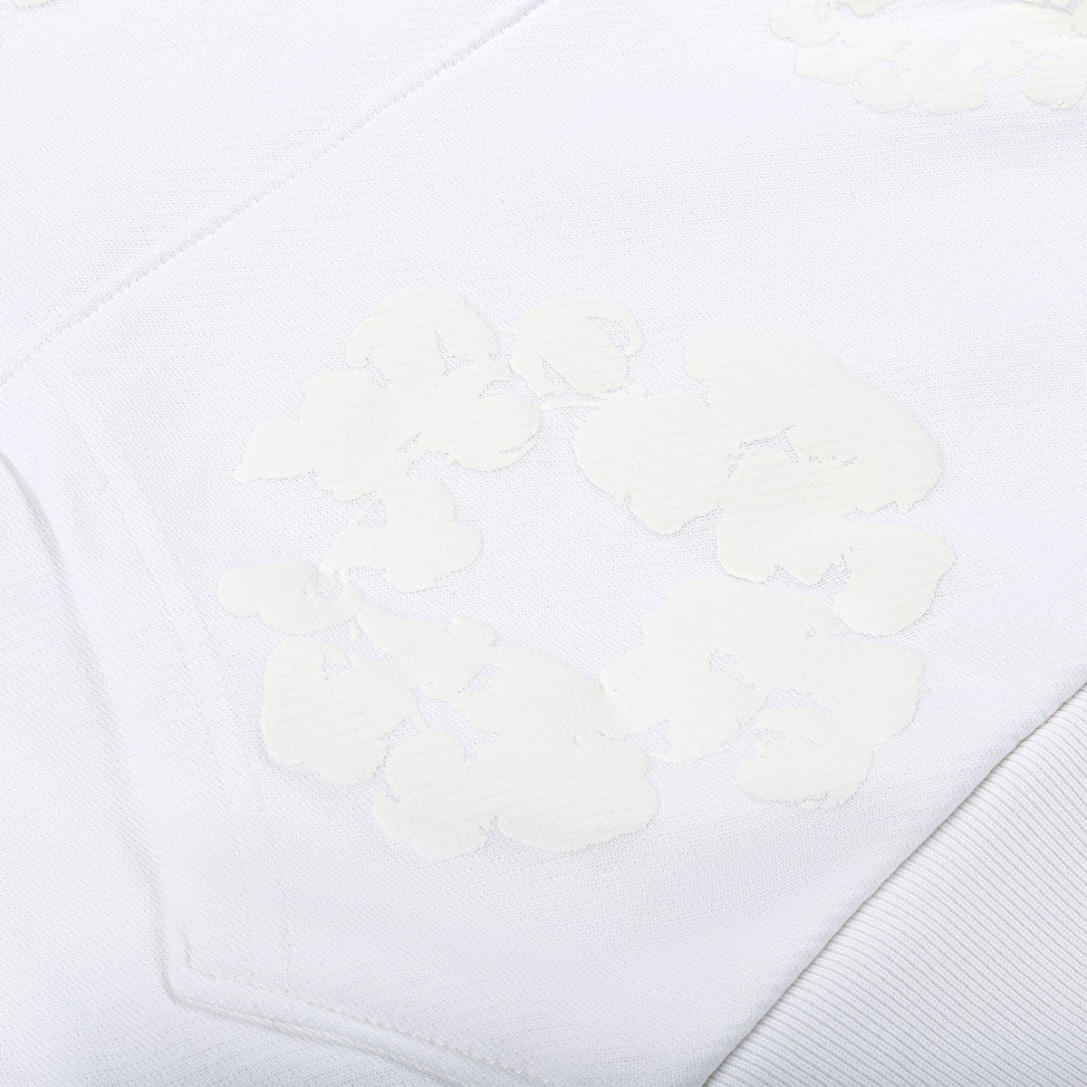 Close-up of the White Monochrome “Cotton Wreath” Denim Tears Hoodie – Minimal Streetwear Sweatshirt, showing raised, embossed patterns reminiscent of its signature cotton wreath design for subtle texture and shading contrast.