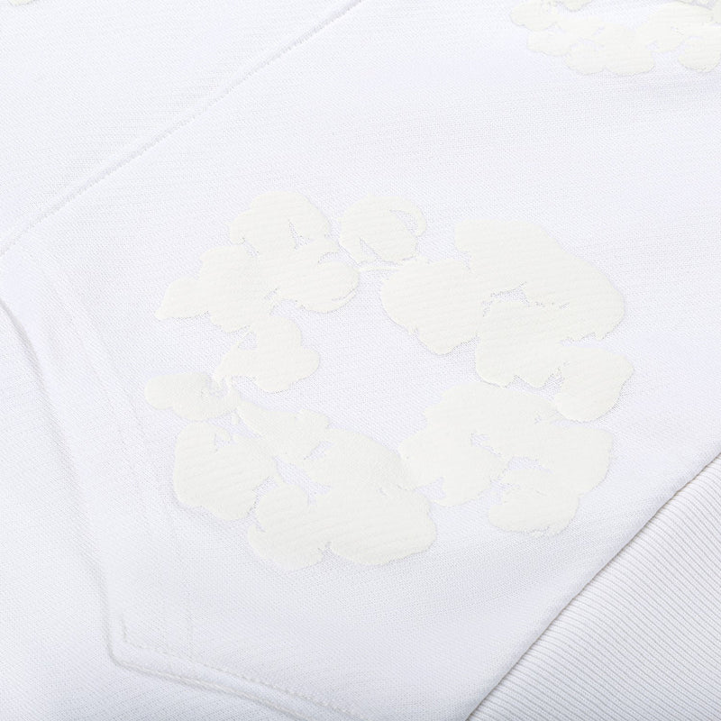 Close-up of the White Monochrome “Cotton Wreath” Denim Tears Hoodie – Minimal Streetwear Sweatshirt, showing raised, embossed patterns reminiscent of its signature cotton wreath design for subtle texture and shading contrast.